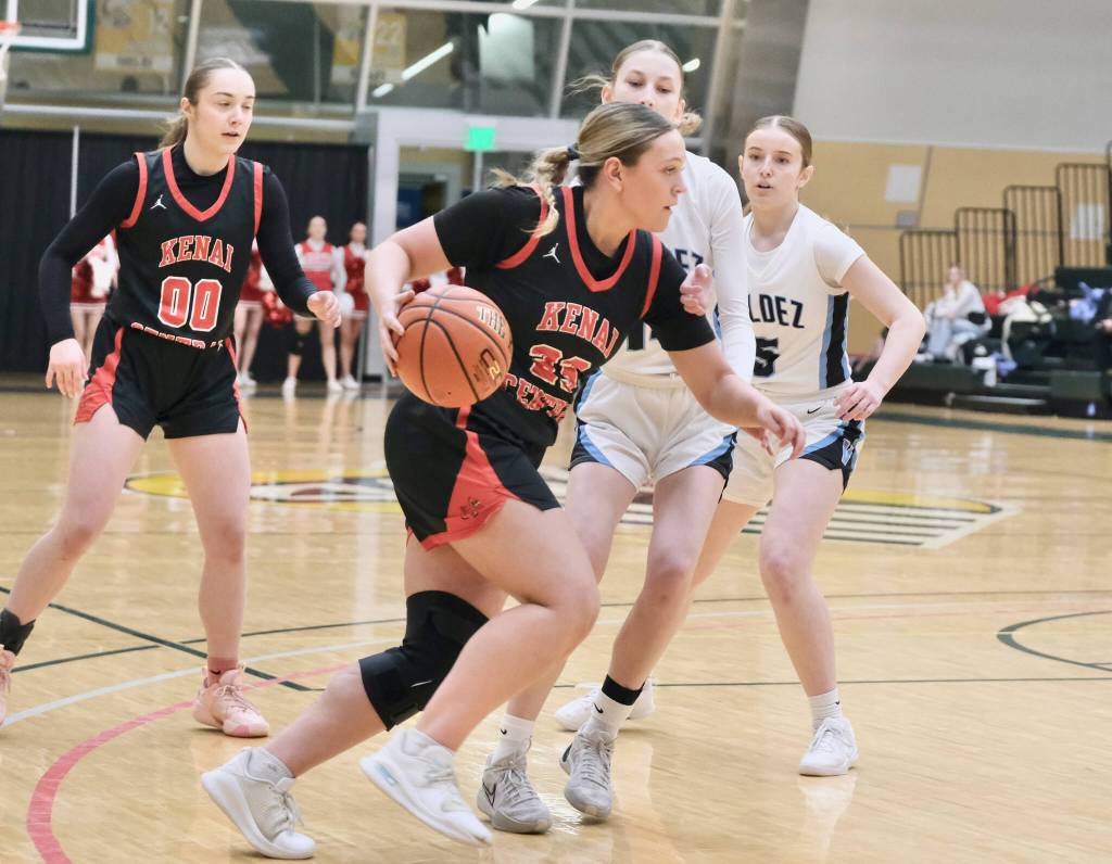 Kenai junior McKenzie Spence (23) drives past Valdez junior Rylee Wade (14) during the Kardinals 43-39 win over the Buccaneers on Wednesday, March 19, 2025, in the 2025 ASAA March Madness Alaska 3A/4A Basketball State Championships at the Alaska Airlines Center in Anchorage, Alaska. (Klas Stolpe / Juneau Empire)