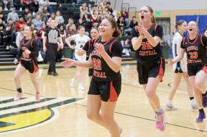 Kenai freshman Bryleigh Williams (22), junior Willow Graham (32) and Ellsi Miller (33) celebrate as they leave the court in the Kardinals' 43-39 win over Valdez on Wednesday, March 19, 2025, at the 2025 ASAA March Madness Alaska 3A/4A Basketball State Championships at the Alaska Airlines Center in Anchorage, Alaska. (Klas Stolpe / Juneau Empire)