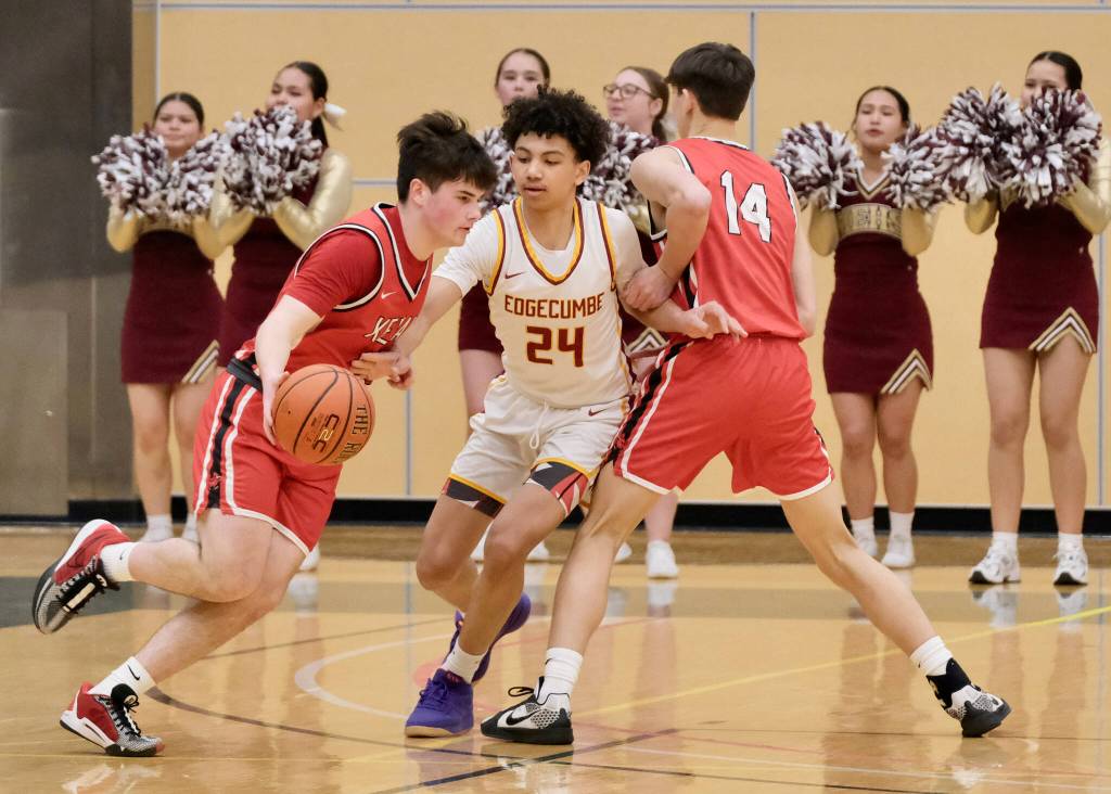Kenai sophomore Reid Titus dribbles around a screen by classmate Miles Metteer (14) as Mt. Edgecumbe sophomore Xavier Gundersen (24) defends Wednesday, March 19, 2025, in the 2025 ASAA March Madness Alaska 3A/4A Basketball State Championships at the Alaska Airlines Center in Anchorage, Alaska. (Klas Stolpe / Juneau Empire)
