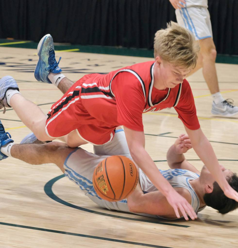 Kenais Eli Smith charges into Valdezs Romen Weber during the Kardinals 71-49 loss to the Buccaneers on Friday, March 21, 2025, in the 4th/6th place game of the 2025 ASAA March Madness Alaska 3A/4A Basketball State Championships at the Alaska Airlines Center in Anchorage, Alaska. (Klas Stolpe / Juneau Empire)