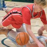 Kenai's Eli Smith charges into Valdez's Romen Weber during the Kardinals 71-49 loss to the Buccaneers on Friday, March 21, 2025, in the 4th/6th place game of the 2025 ASAA March Madness Alaska 3A/4A Basketball State Championships at the Alaska Airlines Center in Anchorage, Alaska. (Klas Stolpe / Juneau Empire)