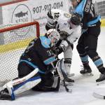 Thomas Gunderson of the Kenai River Brown Bears and Alexios Georgaklis of the Wisconsin Windigo battle in front of Windigo goalie Lucas Szyszka on Saturday, March 22, 2025, at the Soldotna Regional Sports Complex in Soldotna, Alaska. (Photo by Jeff Helminiak/Peninsula Clarion)