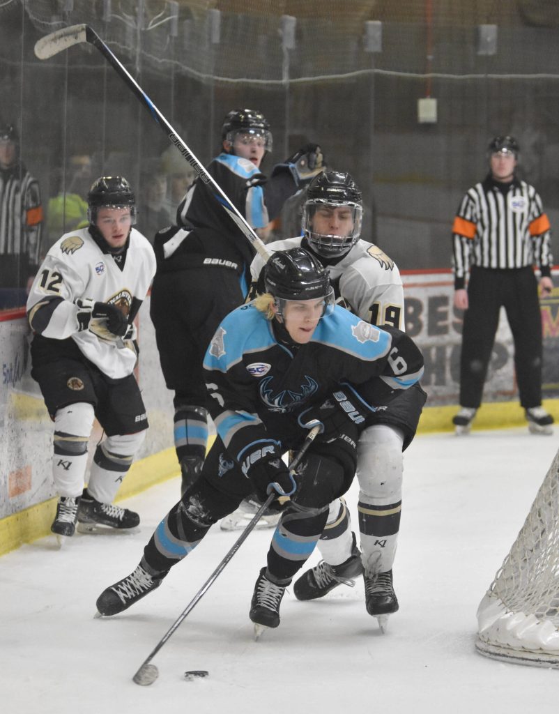 Jackson Ernst of the Wisconsin Windigo shields the puck from Luke Lizak of the Kenai River Brown Bears on Saturday, March 22, 2025, at the Soldotna Regional Sports Complex in Soldotna, Alaska. (Photo by Jeff Helminiak/Peninsula Clarion)
