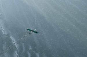 The three survivors of a Sunday afternoon plane crash are found atop the wing of their plane near Tustumena Lake in Kasilof, Alaska, on Monday, March 24, 2025. (Photo by Dale Eicher)