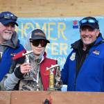 Rhys Borland (center) accepts the Top Youth Angler award during the 2025 Homer Winter King Salmon Tournament on Saturday, March 22, 2025, at the Deep Water Dock on the Homer Spit in Homer, Alaska. (Delcenia Cosman/Homer News)