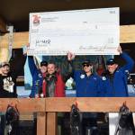 Tournament staff and volunteers help Zach Weimann (center), tournament champion, hold up a check displaying his winnings during the 2025 Homer Winter King Salmon Tournament on Saturday, March 22, 2025, at the Deep Water Dock on the Homer Spit in Homer, Alaska. (Delcenia Cosman/Homer News)
