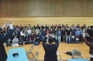 Students and hosts stand for a photo during a luncheon at the end of SoHis first Job Shadow Day, Wednesday at Soldotna Prep School. (Jake Dye/Peninsula Clarion)