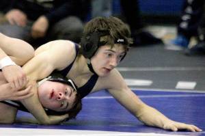 Soldotna’s Ryan Buchanan works to pin Kodiak’s Luke Lester during the boys 119-pound final of the Northern Lights Conference Championships Saturday, Dec. 14, 2024, at Palmer High School in Palmer, Alaska. (Photo by Jeremiah Bartz/Frontiersman)