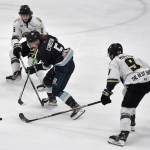 Cole Christian of the Anchorage Wolverines tries to split Andrew Politoski and Riley Mullen of the Kenai River Brown Bears on Saturday, March 29, 2025, at the Soldotna Regional Sports Complex in Soldotna, Alaska. (Photo by Jeff Helminiak/Peninsula Clarion)