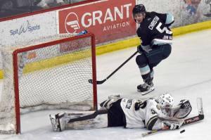 Kenai River Brown Bears goalie Owen Zenone saves a breakaway by Cole Christian on Saturday, March 29, 2025, at the Soldotna Regional Sports Complex in Soldotna, Alaska. (Photo by Jeff Helminiak/Peninsula Clarion)