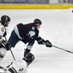 Riley Mullen and Samuel Sisik of the Kenai River Brown Bears and Aaron VanWie of the Anchorage Wolverines battle for the puck Saturday, March 29, 2025, at the Soldotna Regional Sports Complex in Soldotna, Alaska. (Photo by Jeff Helminiak/Peninsula Clarion)
