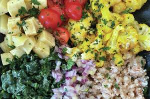 Sweet potatoes, tomatoes, cauliflower, kale, onions and buckwheat are served in this rich, healthy salad. (Photo by Tressa Dale/Peninsula Clarion)