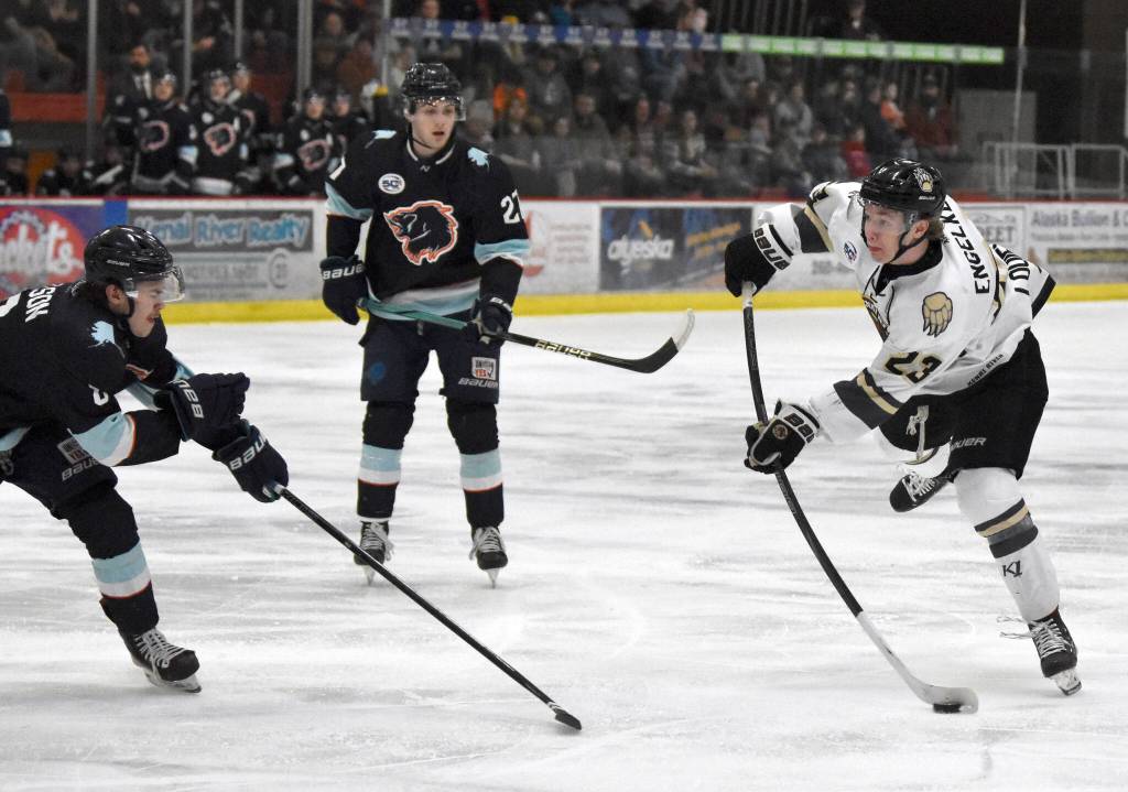 Brady Engelkes of the Kenai River Brown Bears snaps off a shot in front of Drew Nelson of the Anchorage Wolverines on Friday, April 4, 2025, at the Soldotna Regional Sports Complex in Soldotna, Alaska. (Photo by Jeff Helminiak/Peninsula Clarion)