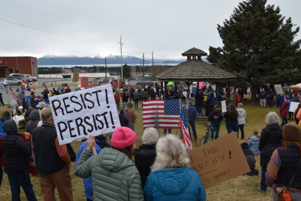 Protesters in Homer hold up signs during the nationwide Hands Off! protest on Saturday, April 5 at WKFL Park in Homer, Alaska. (Chloe Pleznac/Homer News)