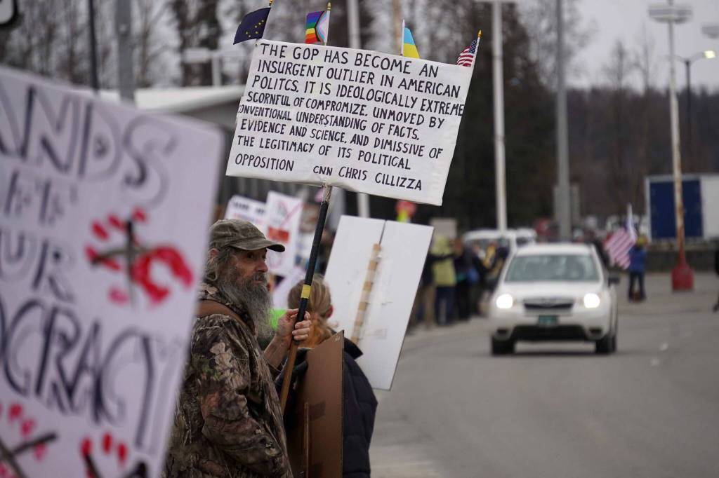 Protesters stand along the Sterling Highway in Soldotna, Alaska, participating in the Remove, Reverse, Reclaim protest organized by Many Voices and Kenai Peninsula Protests as part of the nationwide 50501 effort on Saturday, April 5, 2025. (Jake Dye/Peninsula Clarion)