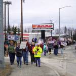 Protesters stand along the Sterling Highway in Soldotna, Alaska, participating in the Remove, Reverse, Reclaim protest organized by Many Voices and Kenai Peninsula Protests as part of the nationwide 50501 effort on Saturday, April 5, 2025. (Jake Dye/Peninsula Clarion)