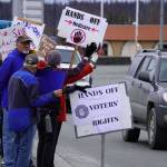 Protesters stand along the Sterling Highway in Soldotna, Alaska, participating in the Remove, Reverse, Reclaim protest organized by Many Voices and Kenai Peninsula Protests as part of the nationwide 50501 effort on Saturday, April 5, 2025. (Jake Dye/Peninsula Clarion)