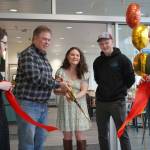 Debbie Adams joins Kenai Mayor Brian Gabriel in cutting a ribbon during the grand opening of Debbies Bistro in its new location in the Kenai Municipal Airport in Kenai, Alaska, on Saturday, April 5, 2025. (Jake Dye/Peninsula Clarion)