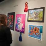 Attendees view the 34th Annual Visual Feast Kenai Peninsula Borough School District Juried Student Art Show during an opening reception at the Kenai Art Center in Kenai, Alaska, on Friday, April 4, 2025. (Jake Dye/Peninsula Clarion)