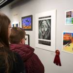Attendees view the 34th Annual Visual Feast Kenai Peninsula Borough School District Juried Student Art Show during an opening reception at the Kenai Art Center in Kenai, Alaska, on Friday, April 4, 2025. (Jake Dye/Peninsula Clarion)
