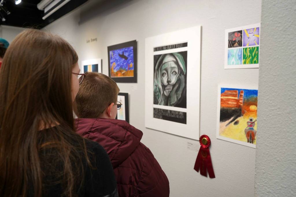 Attendees view the 34th Annual Visual Feast Kenai Peninsula Borough School District Juried Student Art Show during an opening reception at the Kenai Art Center in Kenai, Alaska, on Friday, April 4, 2025. (Jake Dye/Peninsula Clarion)