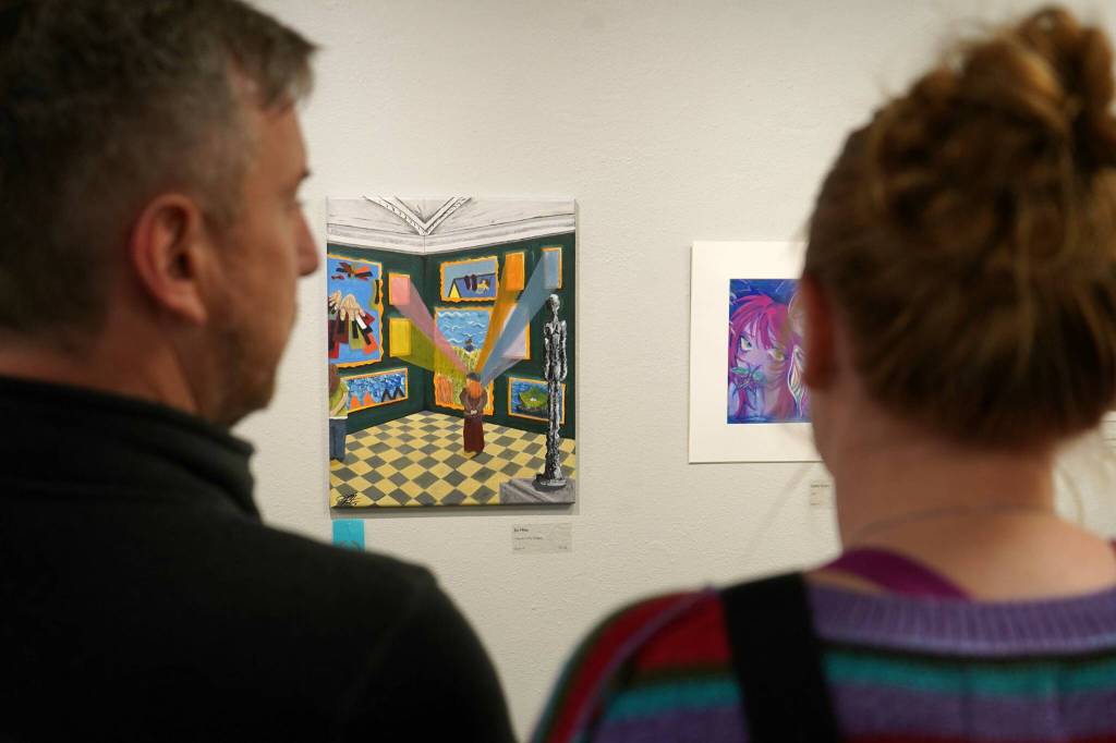 Attendees view the 34th Annual Visual Feast Kenai Peninsula Borough School District Juried Student Art Show during an opening reception at the Kenai Art Center in Kenai, Alaska, on Friday, April 4, 2025. (Jake Dye/Peninsula Clarion)