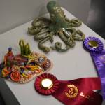 Octoparty, by Kenai Alternative High School student Adelynn DeHoyos, and Green Speckled Ocean, by Soldotna High School Student Savannah Yeager are seen as part of the 34th Annual Visual Feast Kenai Peninsula Borough School District Juried Student Art Show during an opening reception at the Kenai Art Center in Kenai, Alaska, on Friday, April 4, 2025. (Jake Dye/Peninsula Clarion)