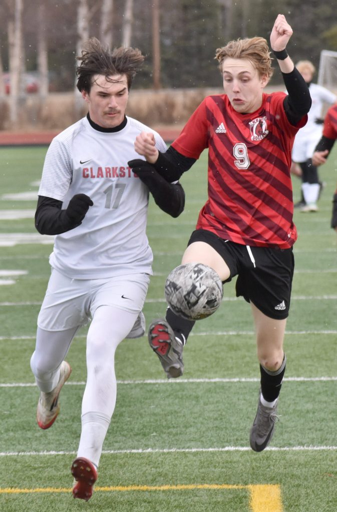 Traysen Hagen of Clarkston (Washington) and Zane James of Kenai Central joust for the ball Monday, April 7, 2025, at Ed Hollier Field at Kenai Central High School in Kenai, Alaska. (Photo by Jeff Helminiak/Peninsula Clarion)