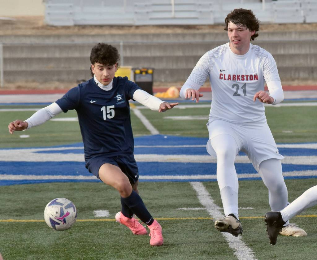 Harold Rudstrom of Soldotna shields the ball from Owen Hoffman of Clarkston (Washington) at Justin Maile Field at Soldotna High School on Wednesday, April 9, 2025. (Photo by Jeff Helminiak/Peninsula Clarion)