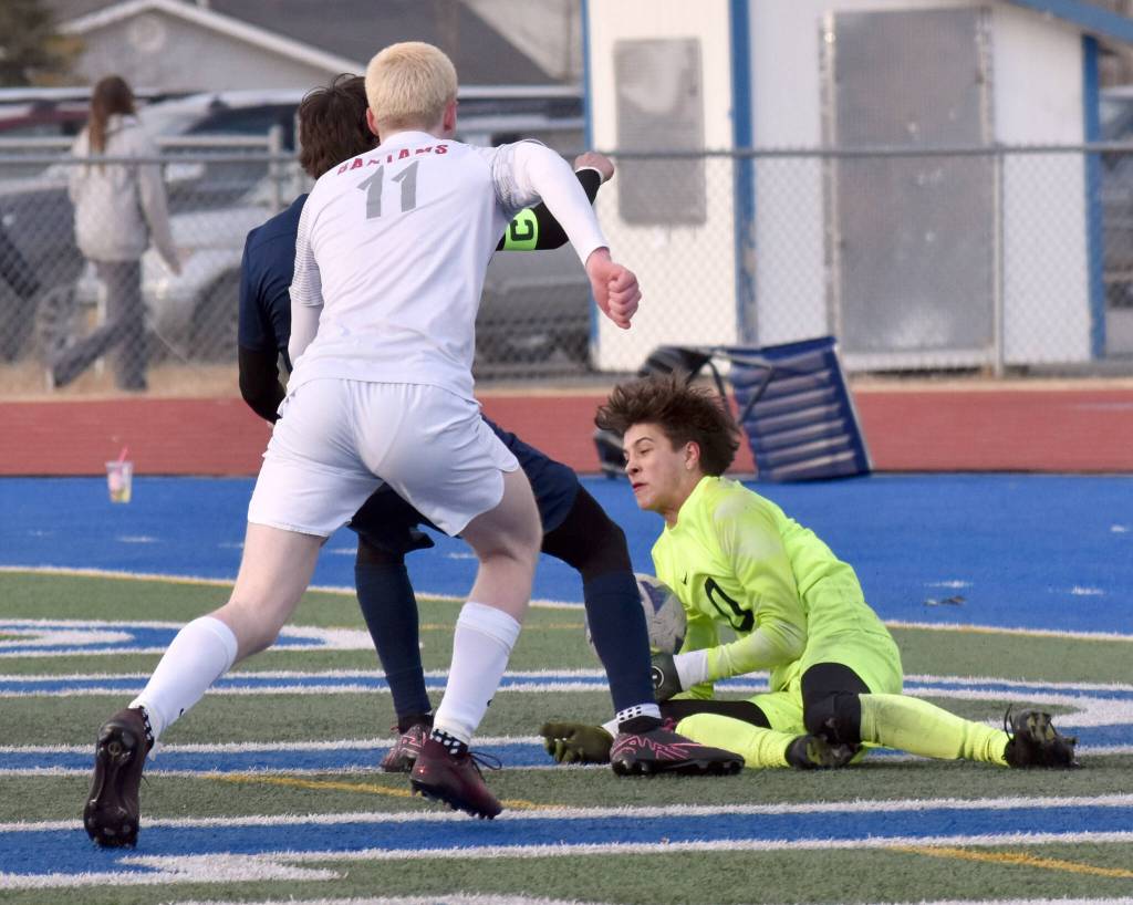 Goalie James LeBret of Clarkston (Washington) makes a save in front of Soldotnas Daniel Heath and Clarkstons Quinlyn Snyder at Justin Maile Field at Soldotna High School on Wednesday, April 9, 2025. (Photo by Jeff Helminiak/Peninsula Clarion)