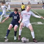 Soldotnas Brody Linton and Quinlyn Snyder of Clarkston (Washington) battle for the ball at Justin Maile Field at Soldotna High School on Wednesday, April 9, 2025. (Photo by Jeff Helminiak/Peninsula Clarion)