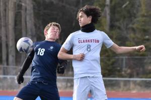 Trevin Moore of Soldotna and Connor Schnatterie of Clarkston (Washington) battle for the ball at Justin Maile Field at Soldotna High School on Wednesday, April 9, 2025. (Photo by Jeff Helminiak/Peninsula Clarion)
