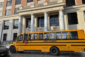 A school bus passes in front of the Alaska Capitol on Tuesday, Feb. 6, 2024. (James Brooks/Alaska Beacon)