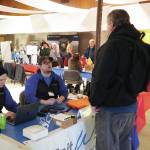 Jake Dye/Peninsula Clarion
SPITwSPOTS employees speak to an attendee of the Kenai Peninsula Job and Career Fair in Kenai on Wednesday.