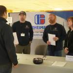 Epperheimer Inc employees speak to attendees of the Kenai Peninsula Job and Career Fair in Kenai, Alaska, on Wednesday, April 16, 2025. (Jake Dye/Peninsula Clarion)