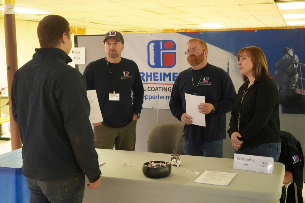 Epperheimer Inc employees speak to attendees of the Kenai Peninsula Job and Career Fair in Kenai, Alaska, on Wednesday, April 16, 2025. (Jake Dye/Peninsula Clarion)