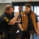 A Kenai police officers speaks to attendees of the Kenai Peninsula Job and Career Fair in Kenai, Alaska, on Wednesday, April 16, 2025. (Jake Dye/Peninsula Clarion)