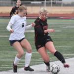 Kenai Centrals Brynnen Hanson dribbles against Soldotnas Keely Sundberg on Tuesday, April 15, 2025, at Ed Hollier Field at Kenai Central High School in Kenai, Alaska. (Photo by Jeff Helminiak/Peninsula Clarion)