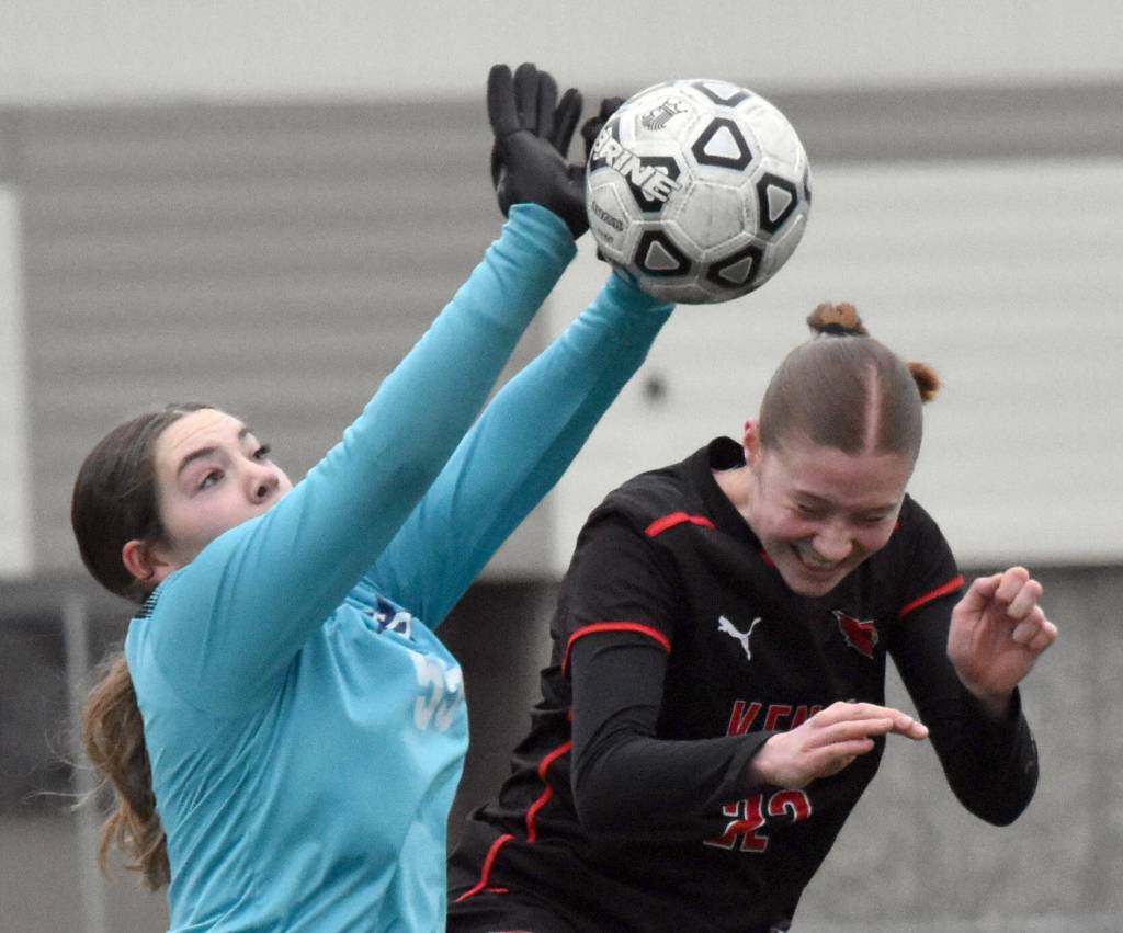 Soldotna goalie Ryan Queen notches a save in front of Kenai Centrals Christine Goering on Tuesday, April 15, 2025, at Ed Hollier Field at Kenai Central High School in Kenai, Alaska. (Photo by Jeff Helminiak/Peninsula Clarion)