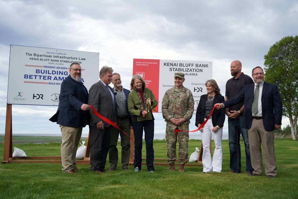 City of Kenai Public Works Director Scott Curtain; City of Kenai Mayor Brian Gabriel; Kenai Peninsula Borough Mayor Peter Micciche; Sen. Lisa Murkowski; Col. Jeffrey Palazzini; Elaina Spraker; Adam Trombley; and Kenai City Manager Terry Eubank cut the ribbon to celebrate the start of work on the Kenai River Bluff Stabilization Project in Kenai, Alaska, on Monday, June 10, 2024. (Jake Dye/Peninsula Clarion)