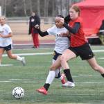 Homers Julianne Techie and Kenai Centrals Christine Goering battle for the ball Thursday, April 17, 2025, at Ed Hollier Field at Kenai Central High School in Kenai, Alaska. (Photo by Jeff Helminiak/Peninsula Clarion)
