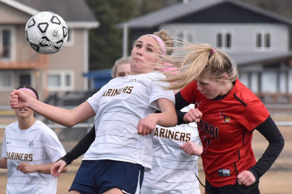 Homers Ruby Hill and Kenai Centrals Tait Cooper battle for the ball Thursday, April 17, 2025, at Ed Hollier Field at Kenai Central High School in Kenai, Alaska. (Photo by Jeff Helminiak/Peninsula Clarion)