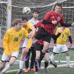 Homers Berend Pearson clears the ball off the line in front of Kenai Centrals Sawyer Vann on Thursday, April 17, 2025, at Ed Hollier Field at Kenai Central High School in Kenai, Alaska. (Photo by Jeff Helminiak/Peninsula Clarion)