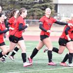 Kenai Centrals Brynnen Hanson (second from right) celebrates her goal against Homer on Thursday, April 17, 2025, at Ed Hollier Field at Kenai Central High School in Kenai, Alaska. (Photo by Jeff Helminiak/Peninsula Clarion)