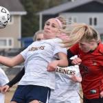 Homer's Ruby Hill and Kenai Central's Tait Cooper battle for the ball Thursday, April 17, 2025, at Ed Hollier Field at Kenai Central High School in Kenai, Alaska. (Photo by Jeff Helminiak/Peninsula Clarion)