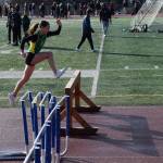 A steeplechaser takes a leap on Friday, April 18 at the Homer High School Invitational Track Meet. (Chloe Pleznac/Homer News)