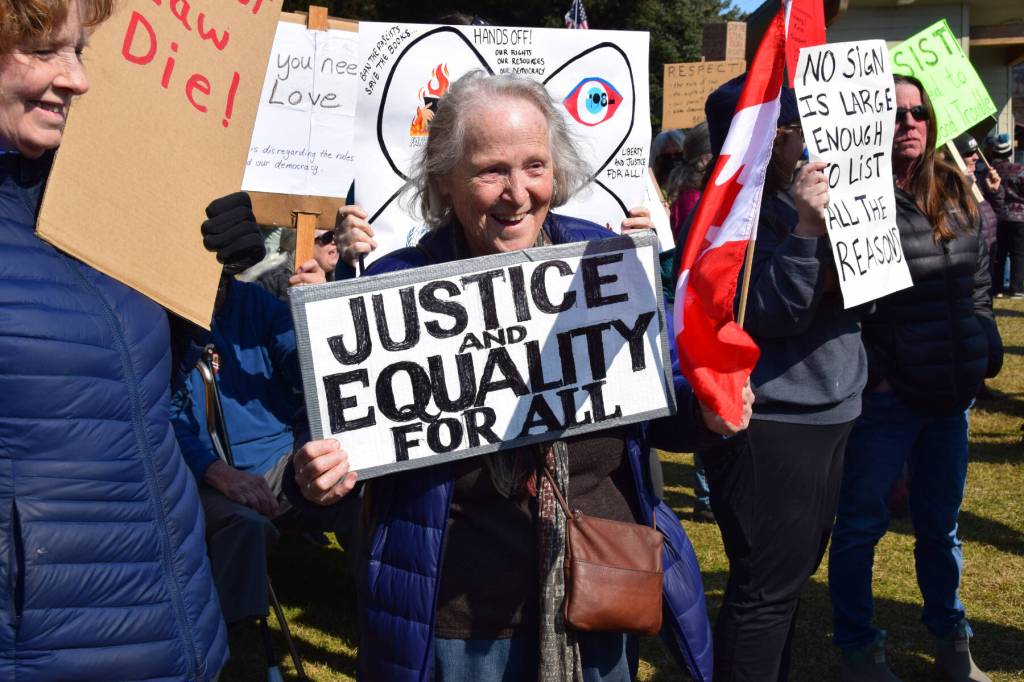 A protester holds a sign that reads JUSTICE AND EQUALITY FOR ALL on Saturday, April 19 at WKFL Park during the Sustained Resistance, Makes a Difference Rally. (Chloe Pleznac/Homer News)