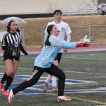 Nikiskis Emily Brannon makes a save in front of Nikiskis Madison Iyatunguk and Soldotnas Lane Hillyer on Tuesday, April 22, 2025, at Justin Maile Field at Soldotna High School in Soldotna, Alaska. (Photo by Jeff Helminiak/Peninsula Clarion)
