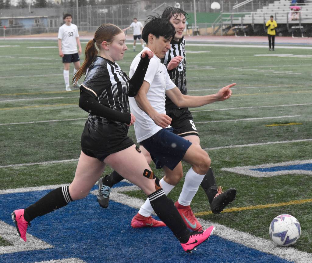 Nikiskis Emma OBrien and Shane Hall and Soldotnas Xavier Brown battle for the ball Tuesday, April 22, 2025, at Justin Maile Field at Soldotna High School in Soldotna, Alaska. (Photo by Jeff Helminiak/Peninsula Clarion)