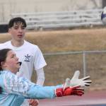 Nikiski's Emily Brannon makes a save in front of Nikiski's Madison Iyatunguk and Soldotna's Lane Hillyer on Tuesday, April 22, 2025, at Justin Maile Field at Soldotna High School in Soldotna, Alaska. (Photo by Jeff Helminiak/Peninsula Clarion)